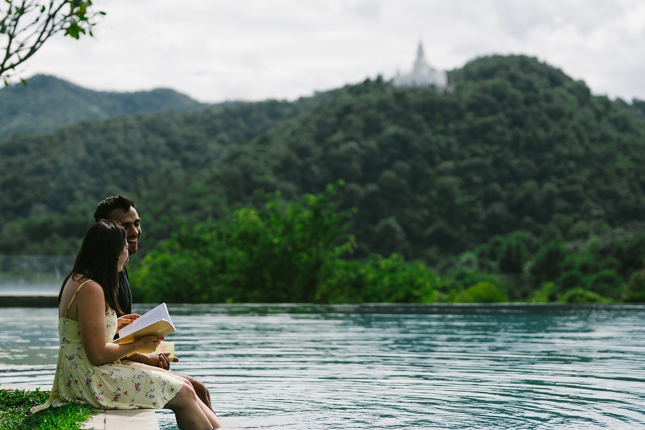 man and woman on dock by lake